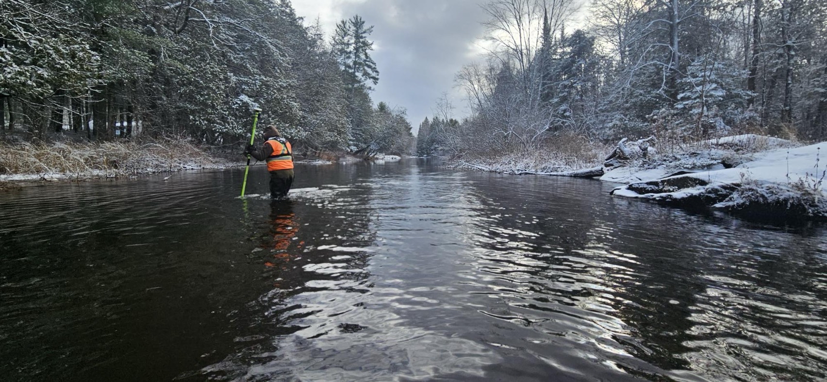 Floodplain Mapping/GIS Specialist Galen Yerex taking a measurement.