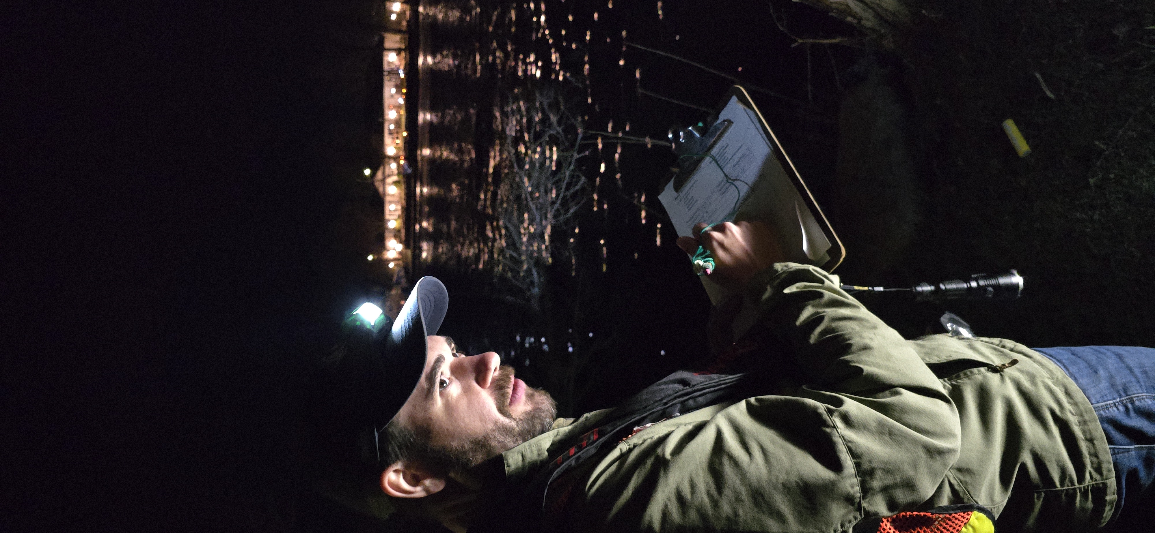 Matthew Wilson, Assistant Watershed Resources Technician at Kawartha Conservation, records walleye numbers during an evening count in Bobcaygeon.